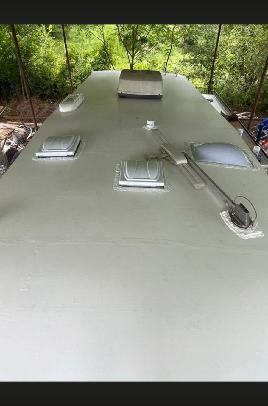 Finished new RV roof with vents and A/C reinstalled